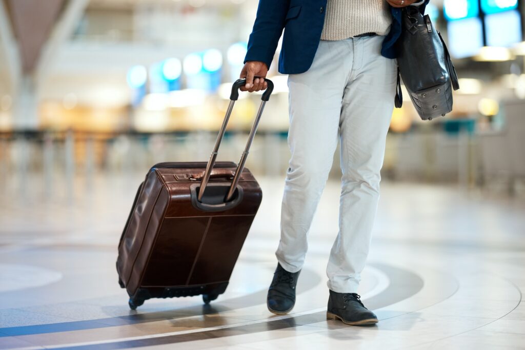 Luggage, airport and black man travel for business opportunity, international career and immigratio